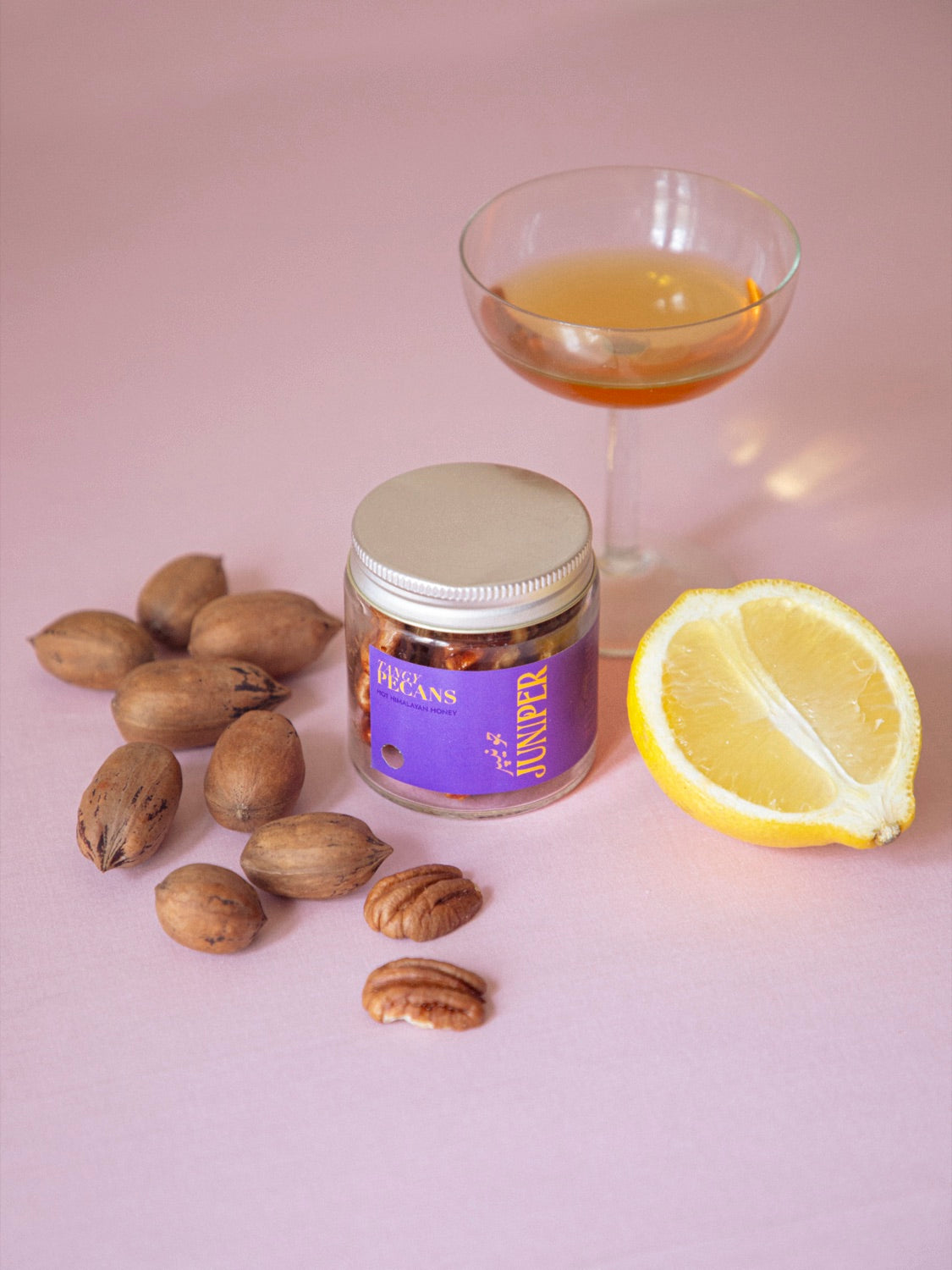 Hot Honey pecans with a coupe glass and lemon